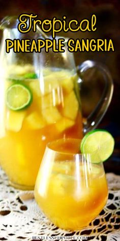 tropical pineapple sangria in glasses with limes on the rim and garnishes