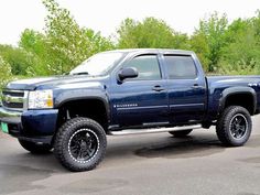 a large blue truck parked in a parking lot