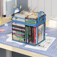 a blue bag sitting on top of a table filled with books