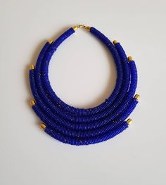 These necklaces are 100% handcrafted using colorful beads. *Simple yet stylish piece to add to your jewelry set* *Perfect for weddings, African themed events or any other occasion. Available in these colors; *Yellow * Blue * Red Dimensions; 18 inches around the neck. **Buy multiple items and pay shipping for 1 item only.The rest ships free. More neckleces here; https://www.etsy.com/shop/TribalTess?ref=seller-platform-mcnav&section_id=21306083 Back to my shop; https://www.etsy.com/shop/Tribal Adjustable Gold Beads Necklace, Blue Multi-strand Necklace With Gold Beads, Tiny Beads Bib Necklaces For Jewelry Making, Blue Necklaces With Gold Round Beads, Blue Necklace With Gold Round Beads, Small Beads Necklace, African Necklace, Necklace Layered, Small Beads