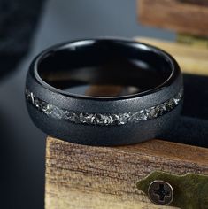 a close up of a black ring on top of a wooden box