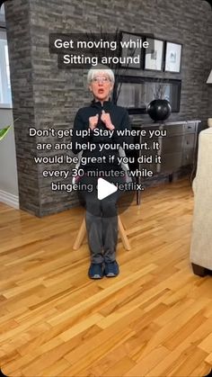 an elderly woman standing in a living room with her hands on her chest and the words, get moving while sitting around