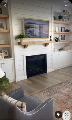 a living room filled with furniture and a fire place in front of a wall mounted tv