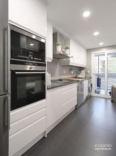 a kitchen with white cabinets and stainless steel appliances