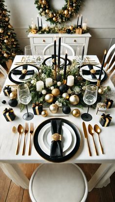 a white table with black and gold place settings on it, surrounded by christmas decorations