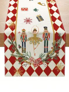 the table cloth is decorated with nutcrackers and holly wreaths on it