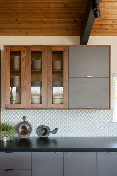 a kitchen with wooden cabinets and black counter tops