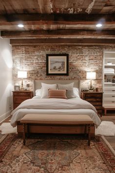 a bedroom with brick walls and white bedding, rugs and lamps on the floor