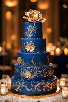 a blue and gold wedding cake on a table