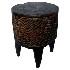 a wooden stool with an intricate design on it