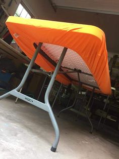 an orange tent sitting on top of a metal stand