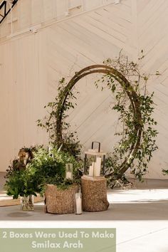 two boxes are used to make a small arch for the wedding ceremony decoration in front of a barn