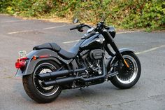 a black motorcycle is parked on the street