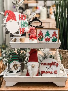 three tiered trays with christmas decorations on them