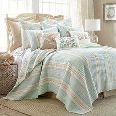 a bed covered in blue and white striped comforter