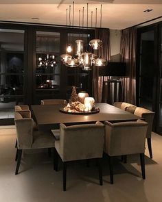 an elegant dining room with chandelier and chairs