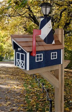 a blue and white house shaped mailbox