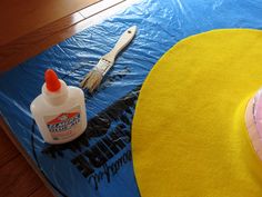 a brush and glue sitting on top of a table