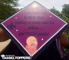 a woman holding up a purple diamond shaped sign with an image of princesses on it