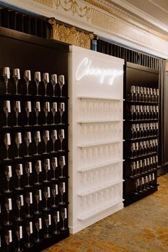 wine glasses are lined up on the shelves