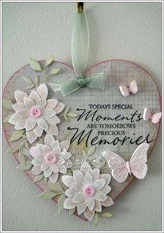 a heart shaped plaque with flowers and butterflies hanging on the wall, says today special moments are tomorrow's precious memories