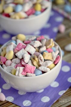 two white bowls filled with marshmallows on top of a purple and white polka dot table cloth