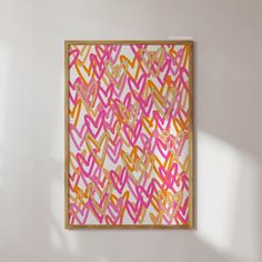 a painting hanging on the wall in an empty room with white walls and pink and orange designs