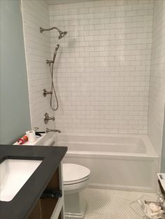 a bathroom with a toilet, sink and bathtub