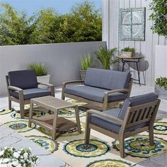 an outdoor patio with furniture and potted plants