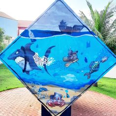 a street sign with an image of various sea animals on the front and side of it