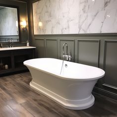 a large white bath tub sitting in a bathroom