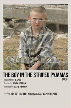 the boy in the striped pyjamas is sitting behind a barbed wire fence