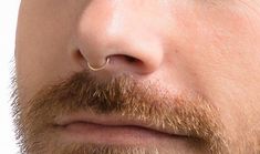 a man with a nose ring on his nose