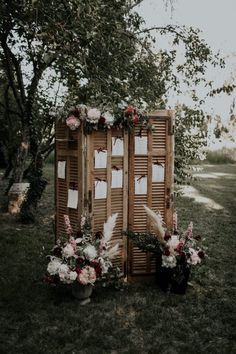 an outdoor ceremony area with flowers and greenery