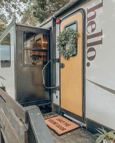 the door is open and there are wreaths on the side of the trailer that's attached to it