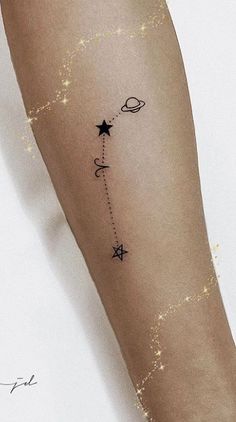 a woman's arm with stars and planets on it