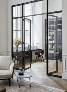 a living room filled with furniture and lots of windows