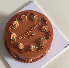 a chocolate birthday cake with roses on it