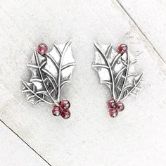 "These festive earrings are perfect for the holidays! These earrings feature Sterling Silver holly leaves with Garnet berries. Dimensions: These earrings measure 3/4\" inches in length and 1/2\" an inch in width with each Garnet berry being 4mm." Holly Earrings, Berry Earrings, Holly And Ivy, Festive Earrings, Herkimer Diamond Earrings, Holly Leaves, Diamond Quartz, Jewelry Christmas, Holly Leaf