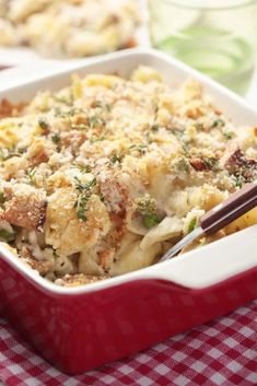 a casserole dish with meat and vegetables in it on a checkered table cloth