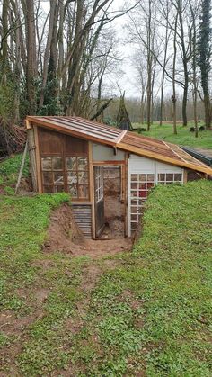 a small chicken coop in the middle of a field