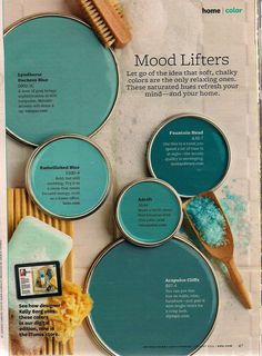 a magazine page with blue paint and wooden utensils