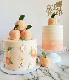 there are two cakes on the table and one is decorated with peaches