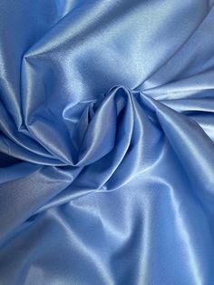 This satin fabric is a stunning shade Cinderella Blue. Approximately 55” wide, this fabric is perfect for skirts, dresses, and drapery. Will combine shipping. Fabric Content: Synthetic We do not accept returns on fabric purchases. We do offer sample swatches of all of our fabrics. Photo on the right is for inspirational purposes as it is made out of a similar fabric, but please note it is not made of the actual fabric. The actual fabric is depicted in the fabric photos. Blue Silk Fabric, Bday Dress, Cinderella Blue, Magazine Layout Design, Air Force Blue, Brocade Fabric, Magazine Layout, Women Helping Women, Blue Satin