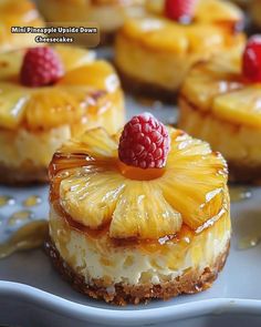 mini pineapple upside down cheesecakes with raspberries on top