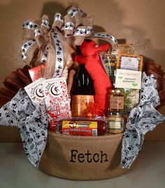 a gift basket filled with wine, liquor and snacks for someone's special occasion