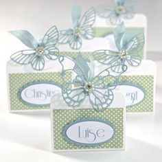 three small boxes with butterflies on them and the word luste written in white letters