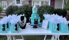 a table that has some bags on it and a cake in the middle with pearls