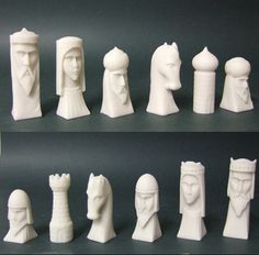 the chess pieces are all white and have different heads on each side, including one man's head