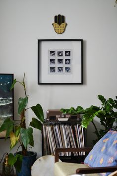 a record player sitting on top of a table next to a potted plant